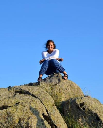 person sitting on a rock