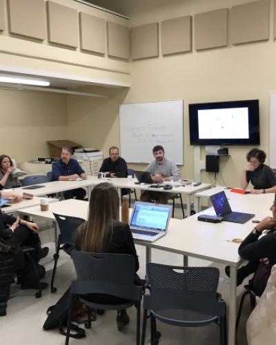 PhD student John Gorczk discusses his grant proposal with CIAMS faculty and fellow grads