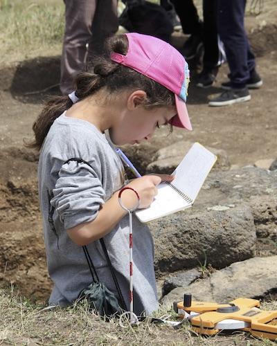 camper practices archaeological drawing